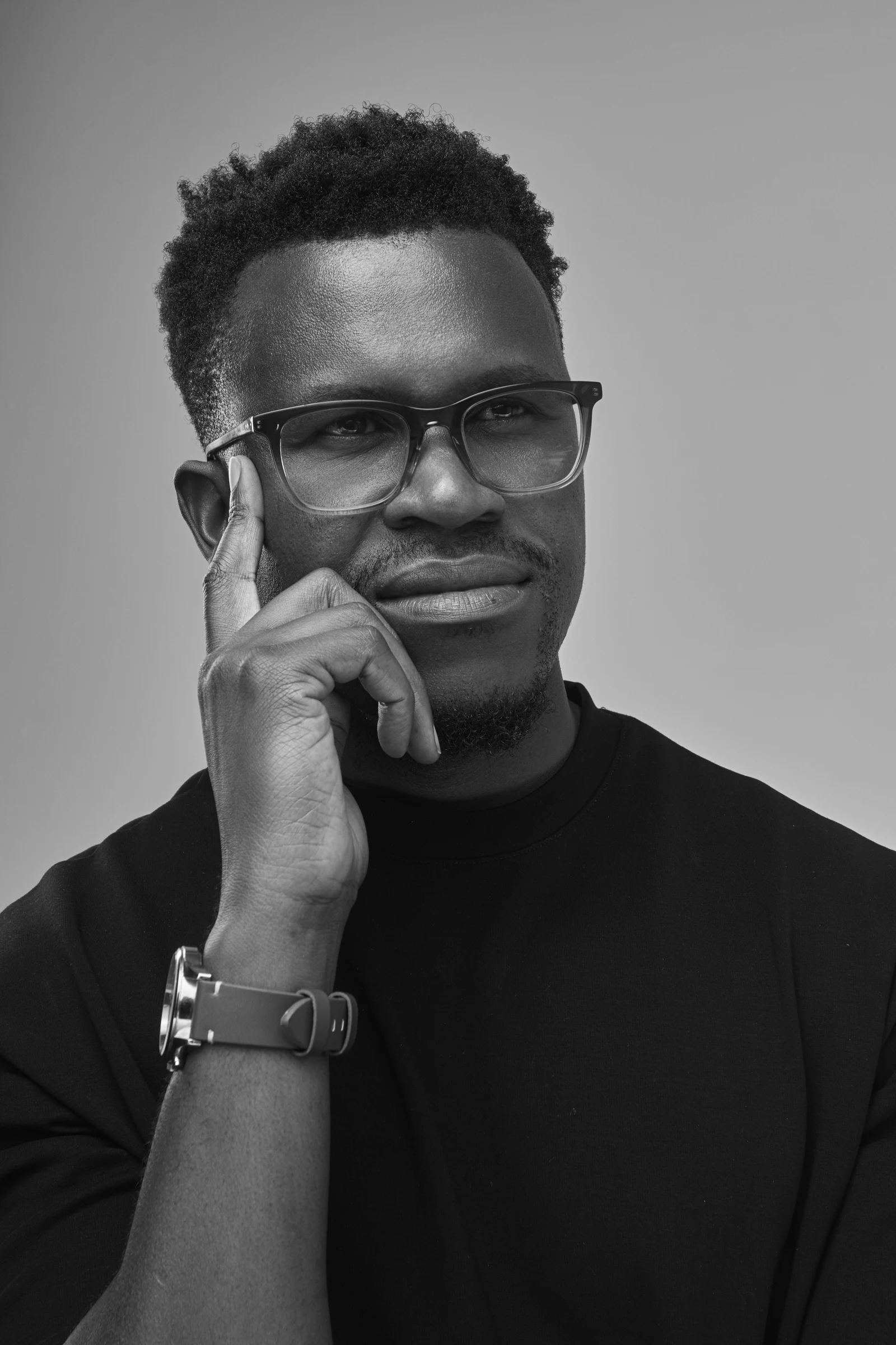 Phinius Sebatsane in a thoughtful portrait, his hand resting against his temple.