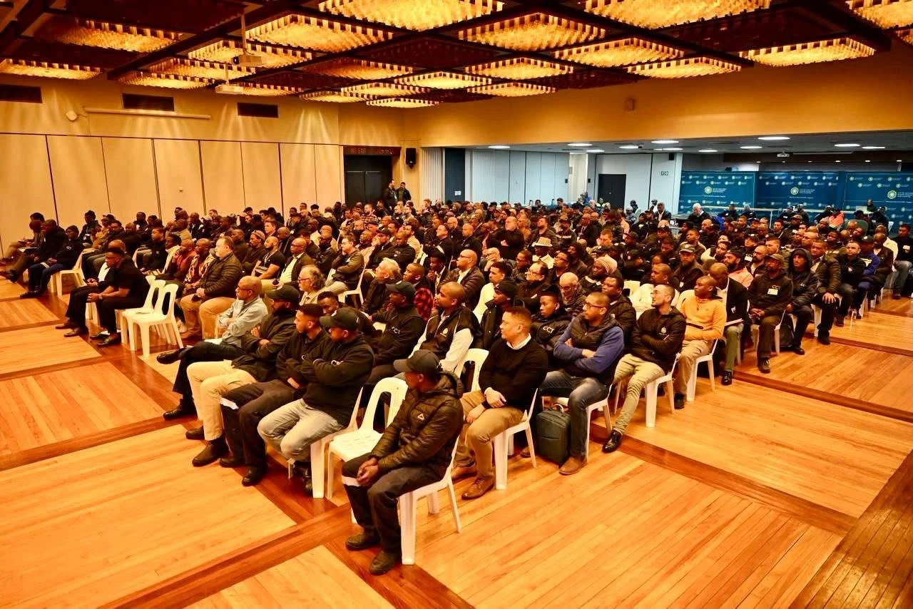 Participants seated together in a hall during an event.